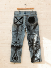 Load image into Gallery viewer, Cesar Platero hand-painted blue denim jeans with large black and gray abstract shapes, circles, lines, and expressive graphic artwork.
