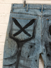 Load image into Gallery viewer, Cesar Platero hand-painted blue denim jeans with large black and gray abstract shapes, circles, lines, and expressive graphic artwork.

