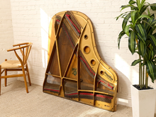 Load image into Gallery viewer, Deconstructed piano harp with gold-tone cast metal frame, exposed strings, tuning pins, red felt, and aged patina

