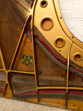 Load image into Gallery viewer, Deconstructed piano harp with gold-tone cast metal frame, exposed strings, tuning pins, red felt, and aged patina

