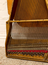 Load image into Gallery viewer, Deconstructed piano harp with gold-tone cast metal frame, exposed strings, tuning pins, red felt, and aged patina

