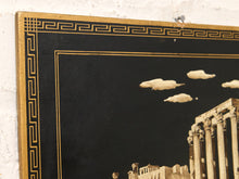 Load image into Gallery viewer, A close-up of a framed wall art print or canvas showing a black background with a gold Greek key border, sepia-toned classical architecture, and a few cream-colored clouds.
