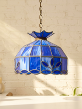 Load image into Gallery viewer, Vintage Tiffany-style pendant lampshade with cobalt blue stained glass panels, dark metal leading, decorative border, and chain
