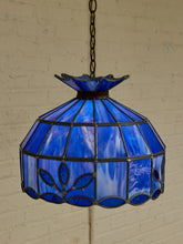 Load image into Gallery viewer, Vintage Tiffany-style pendant lampshade with cobalt blue stained glass panels, dark metal leading, decorative border, and chain
