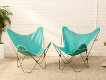 Load image into Gallery viewer, Pair of vintage aqua butterfly chairs with turquoise fabric sling seats, white trim, and slender metal frames

