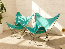 Load image into Gallery viewer, Pair of vintage aqua butterfly chairs with turquoise fabric sling seats, white trim, and slender metal frames

