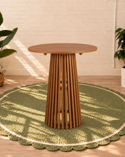 Load image into Gallery viewer, Vivian 31-inch round bar table in warm teak with slatted tabletop and tall sculptural vertical slat pedestal base
