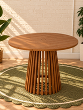 Load image into Gallery viewer, Image 1 of 5: Vivian 39-inch round dining table in warm teak with slatted tabletop, umbrella hole, and sculptural vertical slat pedestal base
