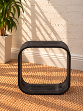 Load image into Gallery viewer, Walter side table in Midnight Cafe Mindi wood with a rounded rectangular top, curved arch-style sides, and visible natural wood grain.
