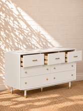 Load image into Gallery viewer, Image 4 of 4: Yvette 7-drawer dresser in Chalk White with polished gold details and elevated legs
