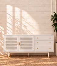 Load image into Gallery viewer, Image 1 of 4: Yvette TV stand in Chalk White with three drawers, two-door storage cabinet, gold details, and elevated legs
