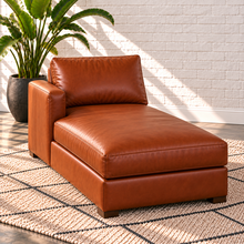 Load image into Gallery viewer, Image 11 of 14: Simulated Hollis left-arm chaise in Mont Blanc Caramel leather, 36 inches wide by 63 inches deep, with one continuous cushion and arm on the viewer's left, in a styled Sunbeam setting.
