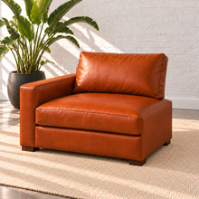 Load image into Gallery viewer, Image 6 of 14: Simulated Hollis 37-inch left-arm modular chair in Mont Blanc Caramel leather, with arm on the viewer's left and open right side, styled with a plain ivory rug and bird-of-paradise plant.
