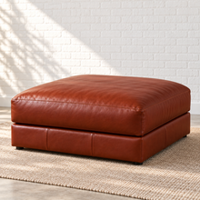 Load image into Gallery viewer, Image 5 of 5: Simulated Montara square bumper ottoman in Brighton Hero brown leather, with a cushioned top and low upholstered base in Sunbeam’s white brick setting.
