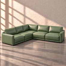 Load image into Gallery viewer, Image 4 of 18: Simulated Orinda five-piece L-shaped modular sectional in sage green Sequoia Rainforest leather, with two end chairs, two armless chairs and a square corner, without accent pillows in the Sunbeam white brick setting.
