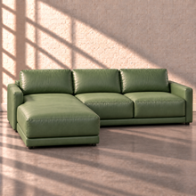 Load image into Gallery viewer, Image 3 of 18: Simulated Orinda two-piece leather sectional with an integrated left-arm chaise featuring one continuous long seat cushion and a right-arm two-seat sofa, in sage green Sequoia Rainforest leather without accent pillows.
