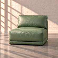 Load image into Gallery viewer, Image 10 of 18: Simulated Orinda individual armless chair module in sage green Sequoia Rainforest leather, without accent pillows, in the Sunbeam white brick setting.
