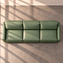 Load image into Gallery viewer, Image 9 of 18: Simulated Orinda three-piece sofa, overhead view in sage green Sequoia Rainforest leather, without accent pillows, in the Sunbeam white brick setting.
