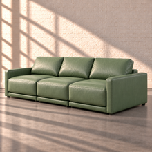 Load image into Gallery viewer, Image 8 of 18: Simulated Orinda three-piece sofa, right side angle in sage green Sequoia Rainforest leather, without accent pillows, in the Sunbeam white brick setting.
