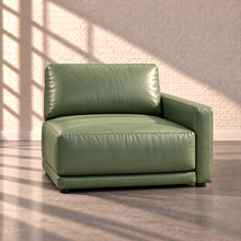 Load image into Gallery viewer, Image 16 of 18: Simulated Orinda individual right-arm chair module in sage green Sequoia Rainforest leather, without accent pillows, in the Sunbeam white brick setting.

