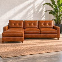 Load image into Gallery viewer, Image 2 of 13: Solano 103-inch two-piece sectional in distressed Sequoia Fawn caramel leather with tufted backs and a chaise on the viewer’s left.
