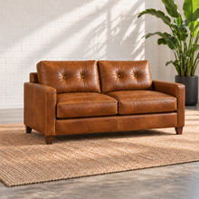 Load image into Gallery viewer, Image 3 of 3: Solano 71-inch condo sofa in distressed Sequoia Fawn caramel leather with two seat cushions, tufted backs, slim arms and walnut legs.
