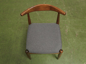 Dark wood single chair with gray seat
