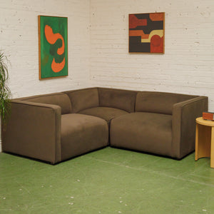 Dark green three-piece modular sectional corner sofa